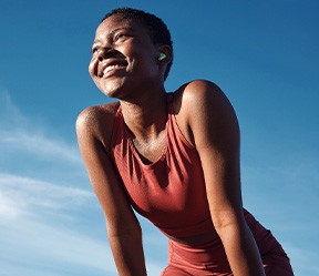 Woman smiling while exercising outside