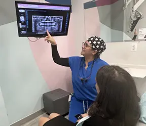 Dentist and patient looking at digital x-rays