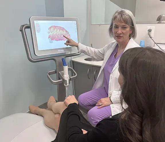 Dentist and patient looking at digital impressions