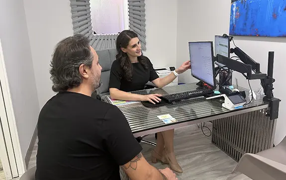 Dental team member and patient reviewing in house dental savings plan options