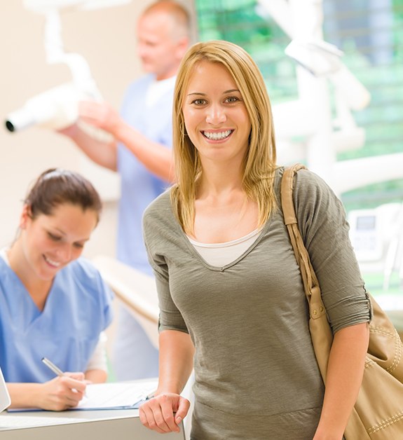 Woman turning in dental insurance forms