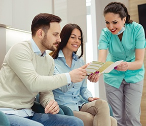 Dental team member explaining in network coverage to dental patients