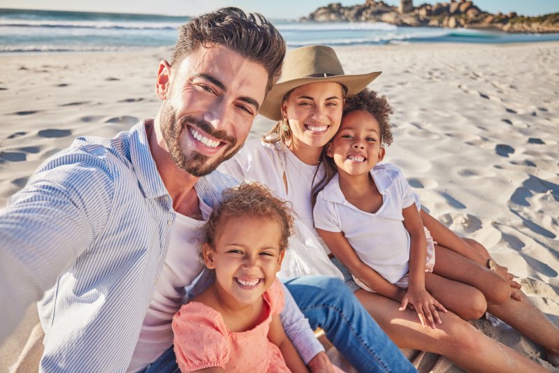 Family enjoying the beach after a dental checkup
